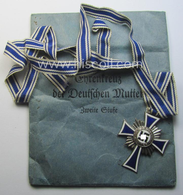 'Ehrenkreuz der deutschen Mutter - zweite Stufe' (or: silver-class mothers'-cross) that came mounted onto its long-sized ribbon and that came stored in its period pouch by the (unusual!) maker: 'Gebr. Gloerfeld K.G. - Lüdenscheid'