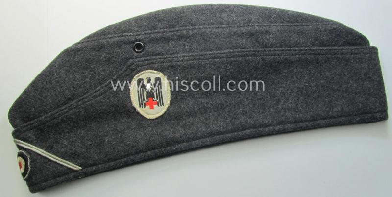 Darker-greyish-blue-coloured, so-called: German Red Cross (ie. 'Deutsches Rotes Kreuz' or: 'DRK' EM- (ie. NCO-) type side-cap (ie. 'Schiffchenmütze für Mannschaften u. Uffz. des deutschen Rotes Kreuzes')
