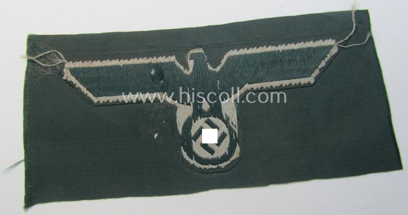 WH (Heeres) early- (ie. pre-war-) period- and/or greyish-coloured breast-eagle of the: 'M36'- (ie. 'M40'-) pattern as was executed in the 'BeVo'-weave pattern on a darker-green-coloured background