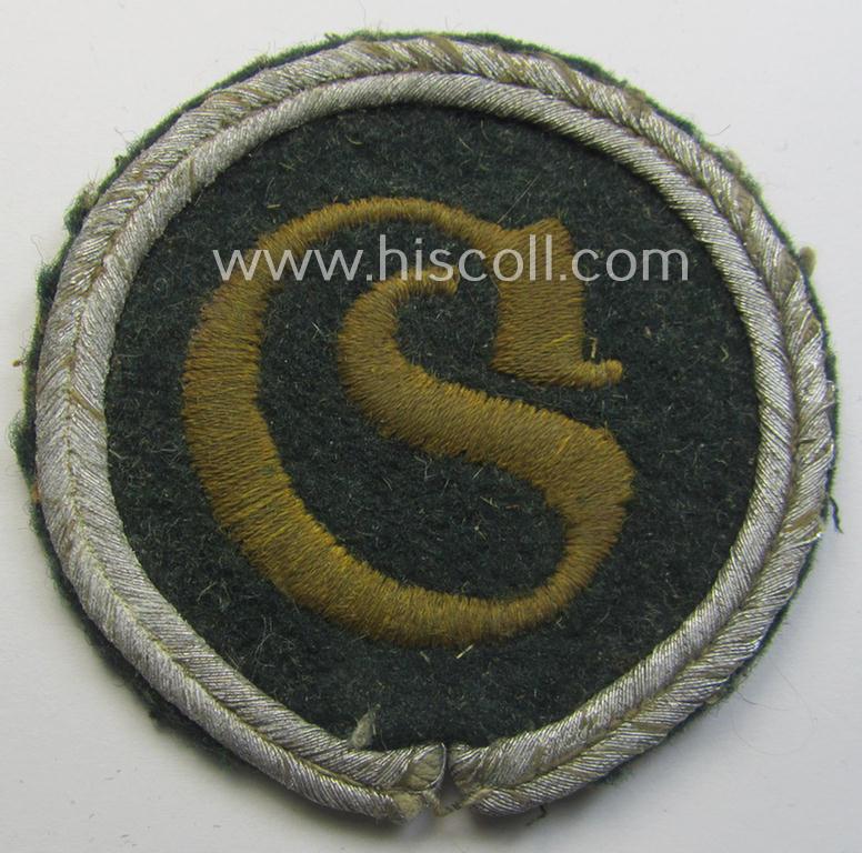WH (Heeres) machine-embroidered, trade- and/or special-career insignia (ie. 'Tätigkeitsabzeichen') as executed on a darker-green-coloured background as was intended for a: 'geprüfter Schirrmeister'