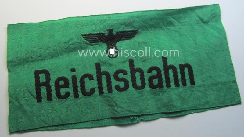 DRB- (ie. 'Deutsche Reichsbahn'-) related armband entitled: 'Reichsbahn' being of the 'entirely-woven'-type onto (typical) silk-like cloth in a technique similar to the 'BeVo'-weave pattern