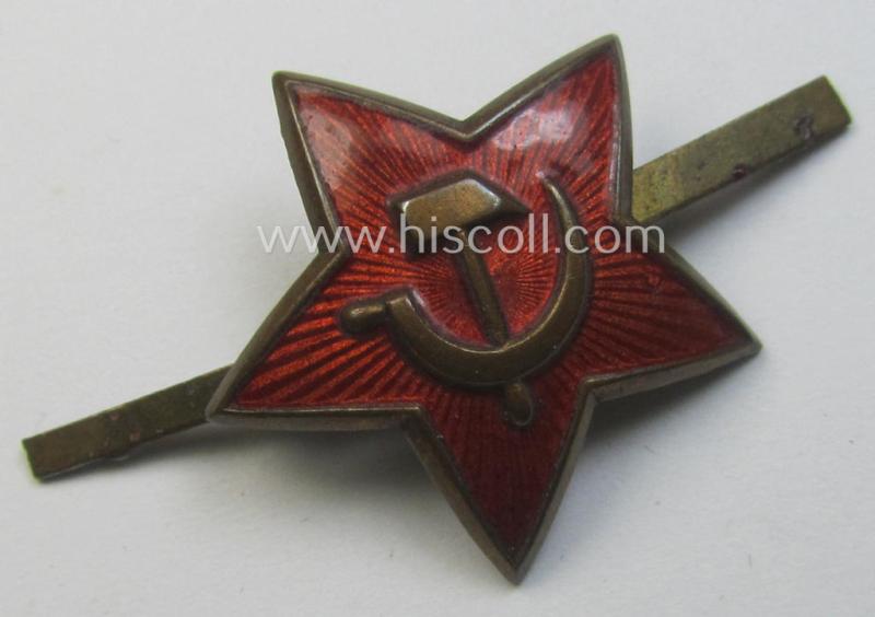 Unusal item that originated from a German soldier: a Russian, smaller-sized and/or WWII-period, enamelled star-shaped cap-badge showing the communist logo on a bright-red-coloured surface