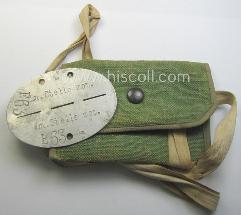 Aluminium-based WH (Luftwaffe) ie. 'Luftnachrichten'-related ID-disc (ie. 'Erkennungsmarke') bearing the stamped unit-designation that reads: 'Ln.Stelle mot - E63' and that comes stored in its period (linnen-based) pouch