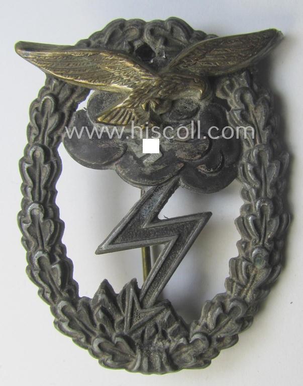 Relic- (ie. denazified), mid- (ie. later-) war-period, zinc- (ie. 'Feinzink'-) based version of a WH (Luftwaffe) 'Erdkampfabzeichen' as was produced by the: 'J.E. Hammer u. Söhne'-company