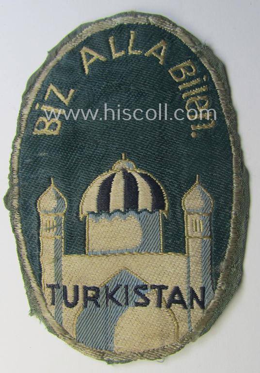 Truly used- and/or worn, 'BeVo'-type armshield (of the first pattern!) entitled: 'Biz Alla Bilen - Turkistan' (being a piece that was intended for a volunteer who served within the: 'Deutsche Wehrmacht' ie. within the: 'Turkistanisches Legion')