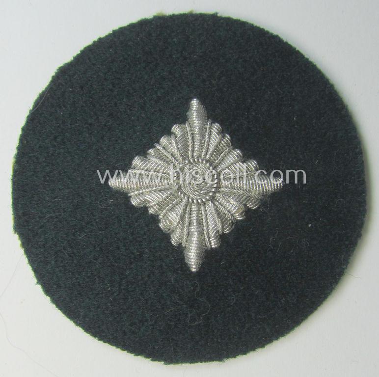 WH (Heeres) rank-insignia (ie. arm-roundel) as was specifically intended for usage by an: 'Oberschütze' (being an interesting hand-embroidered example as executed in silverish-coloured braid onto a darker-green-coloured background)