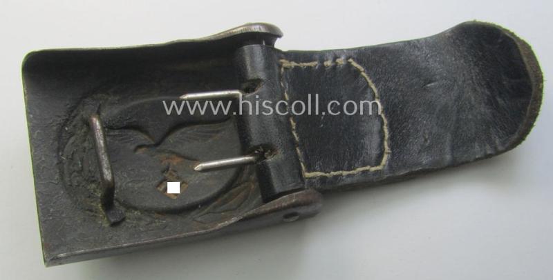 WH (Luftwaffe) bluish-grey-coloured, steel-based belt-buckle being a maker- (ie. 'H. Aurich'-) marked- and/or: '1942'-dated example that comes mounted onto its leather-based tab