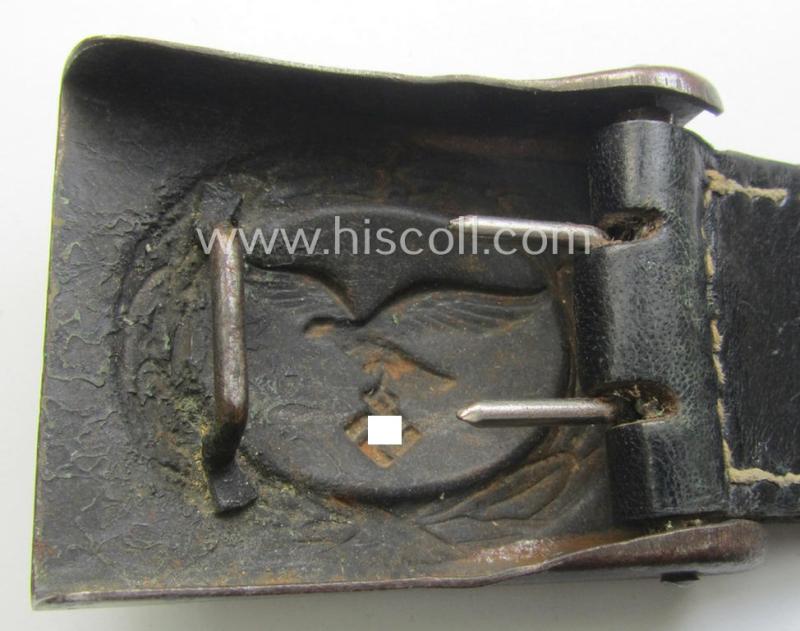 WH (Luftwaffe) bluish-grey-coloured, steel-based belt-buckle being a maker- (ie. 'H. Aurich'-) marked- and/or: '1942'-dated example that comes mounted onto its leather-based tab