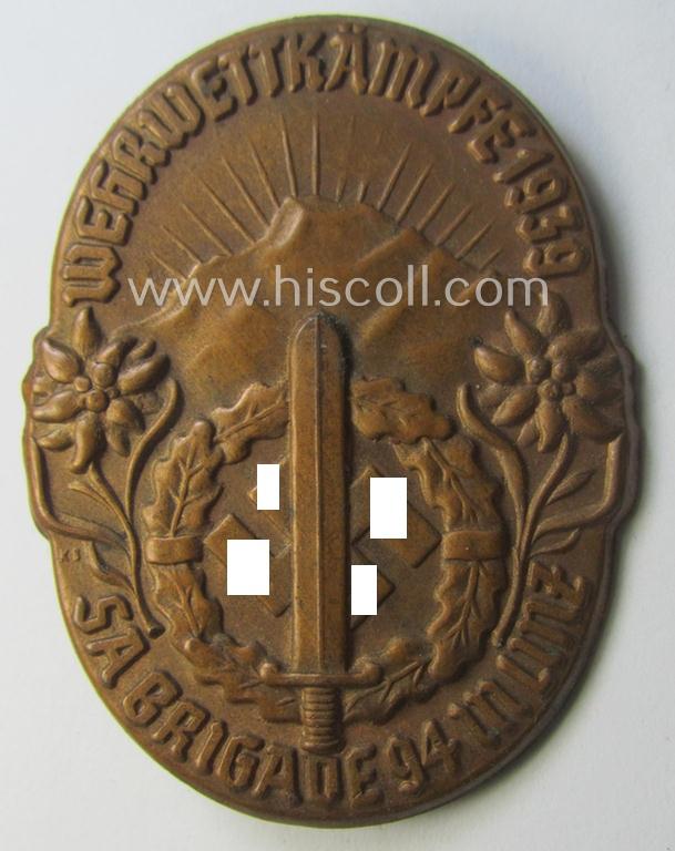 Commemorative, golden-bronze-toned and Austrian-related, SA- (ie. 'Sturmabteilungen'-) related 'tinnie' being a non-maker-marked example showing an: 'SA-Sportabzeichen', sunburst and text: 'Wettkämpfe 1939 - SA-Brigade 94 in Linz'