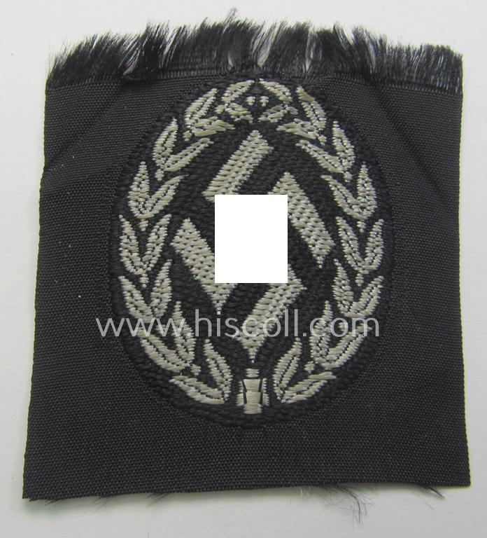 EM- (ie. NCO-) type, so-called: 'Schutzmannschaften' (or: 'Schuma') cap-badge as executed in greyish-coloured thread onto a black-coloured- (ie. 'SS-Polizei'- ie. 'SD'-related-) background