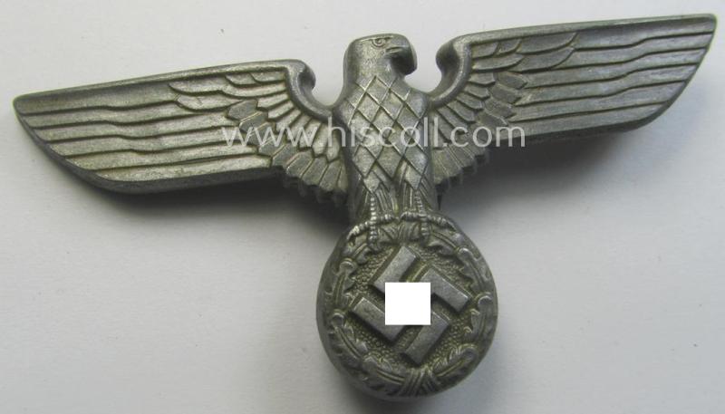 Greyish-silver-coloured- and/or: zinc- (ie. 'Feinzink'-) based (political-style) visor- (ie. 'Schirmmützen'-) cap-eagle being a detailed example that shows an: 'RzM M1/111'-makers'-designation on its back