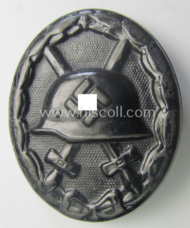 Dual-maker- (ie. 'E.H.'- and/or: '126'-) marked example of a black-class wound-badge (or: 'Verwundeten-Abzeichen in Schwarz') being an example that was produced by the maker (ie. 'Hersteller') named: 'Eduard Hahn'