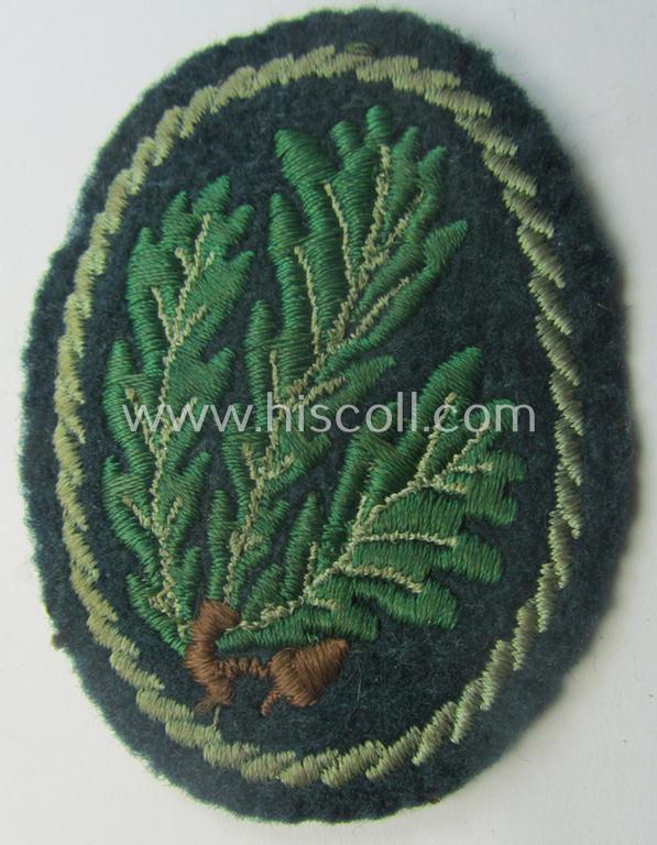 Truly used WH (Heeres) so-called: 'Jäger'-armbadge being a neatly machine-embroidered- and/or multi-coloured version as was executed on darker-green-coloured 'felt-based'-wool