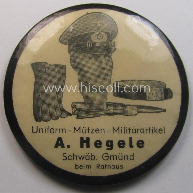 Interesting, WWII-period 'promotional-item' (ie. hand-held mirror or: 'Spiegel') showing an illustration of various military-related accesoiries coupled with the text: 'Uniform - Mützen - Militärartikel - A. Hegele - Schwäb. Gmund - beim Rathaus'