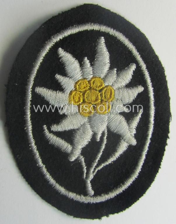 Waffen-SS-pattern, black-coloured sleeve-insignia (ie. 'Ärmelabzeichen') depicting an: 'Edelweiss'-flower as used by the various 'Gebirgsjäger'- (ie. mountain-troops-) related divisional-staff