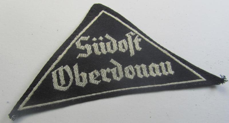 'HJ' ('Hitlerjugend') ie. 'BDM' ('Bund Deutscher Mädel') district-triangle (ie. 'Gebietsdreieck') entitled: 'Südost Oberdonau' (being a 'virtually mint' example that retains its period-attached, paper-based so-called: 'RzM'-etiket)