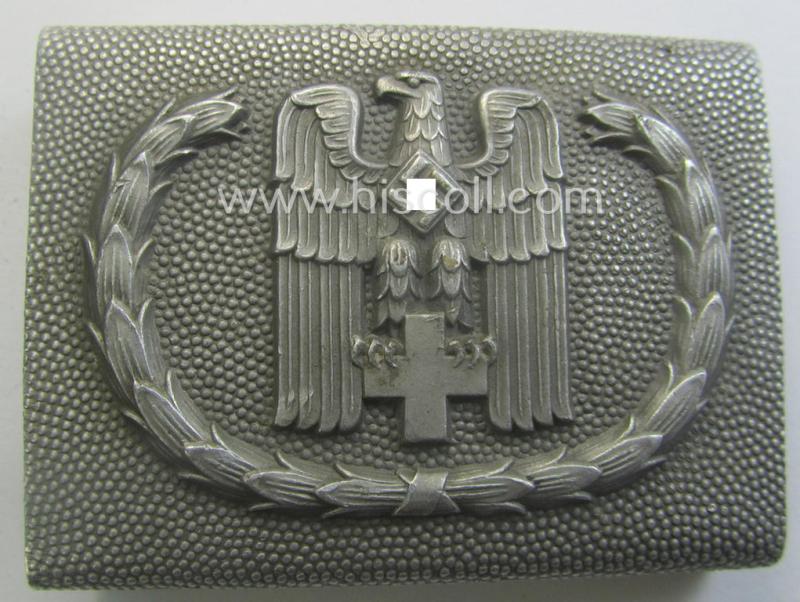 Aluminium-based, so-called: DRK (ie. 'Deutsches Rotes Kreuz'), enlisted-mens'- (ie. NCO-) type belt-buckle being a clearly maker- (ie. 'Ges.Gesch. 1'-) marked example