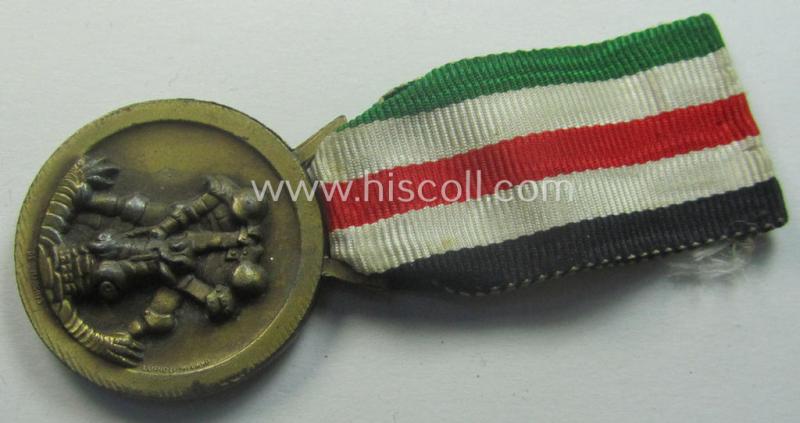 Golden-bronze-coloured (and zinc-based!) example of a: 'Deutsch-Italienische Feldzugsmedaille' (or: German-Italian campaign-medal) that comes mounted onto its (regular-sized) piece of original (and minimally faded- ie. stained!) ribbon