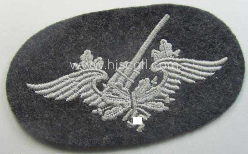 Machine-embroidered WH (Luftwaffe) trade- ie. special-career-patch as was intended for: 'Flak-Artillerie'-staffmembers and that comes in a probably issued but never worn- (ie. 'virtually mint'-), condition
