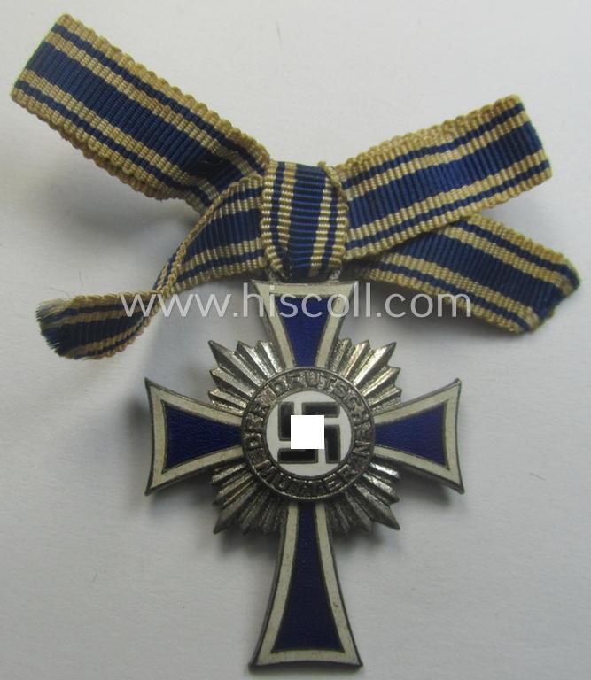 'Ehrenkreuz der deutschen Mutter - zweite Stufe' (or: silver-class mothers'-cross) that came mounted onto its (unusally seen!) 'bow-shaped' ribbon as issued and recently found