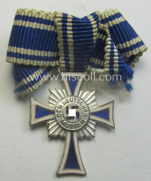 Miniature of an: 'Ehrenkreuz der deutschen Mutter - zweite Stufe' (or: silver-class mothers'-cross) being a non-maker-marked example that comes in an overall nice- (albeit moderately worn- ie. used-), condition