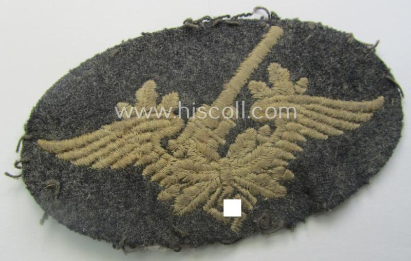 Machine-embroidered WH (Luftwaffe) trade- ie. special-career-patch as was intended for: 'Flak-Artillerie'-staffmembers and that comes in a clearly used- and/or carefully tunic-removed condition