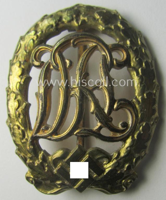 'Reichssportabzeichen DRL in Gold' (or: golden class DRL sports'-badge) being a just moderately worn- ie. used example that is nicely maker- (ie. 'Wernstein - Jena'-) marked on its back