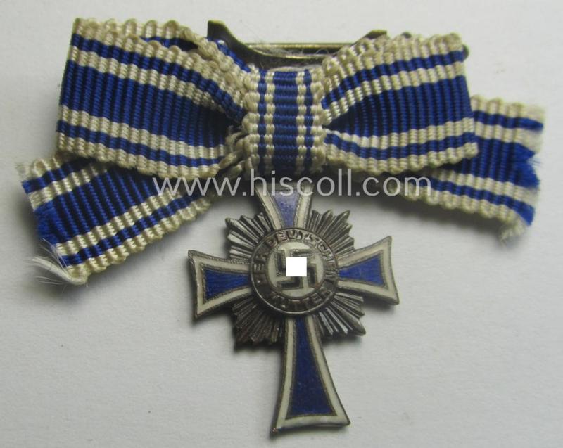 Miniature of an: 'Ehrenkreuz der deutschen Mutter - dritte Stufe' (or: bronze-class mothers'-cross) being a non-maker-marked example that comes in an overall nice- (albeit moderately worn- ie. used-), condition