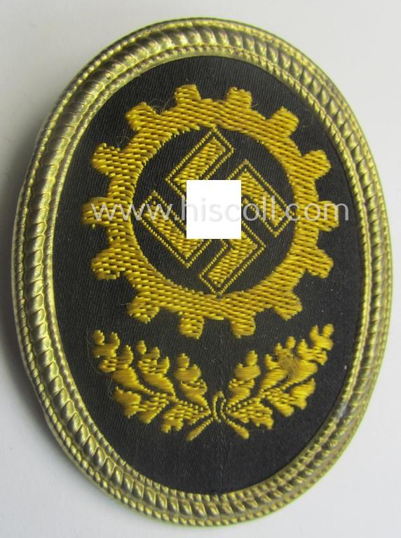 Yellowish-golden-toned- and/or partly machine-embroidered- (ie. 'BeVo'-woven-) so-called: 'DAF' (ie. 'Deutsche Arbeitsfront') cap-badge being an example that is neatly 'RzM - Lieferant No. 357'-marked on its back
