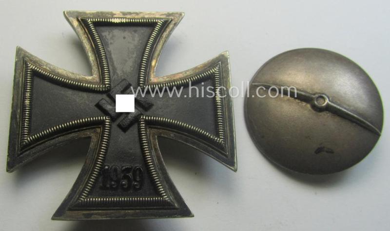 Moderately used, Iron Cross 1st class (or: 'Eisernes Kreuz 1. Klasse') as executed in the scarcely seen so-called: 'screw-back'- (ie. 'An der Schraube'-) pattern being a non-maker-marked example