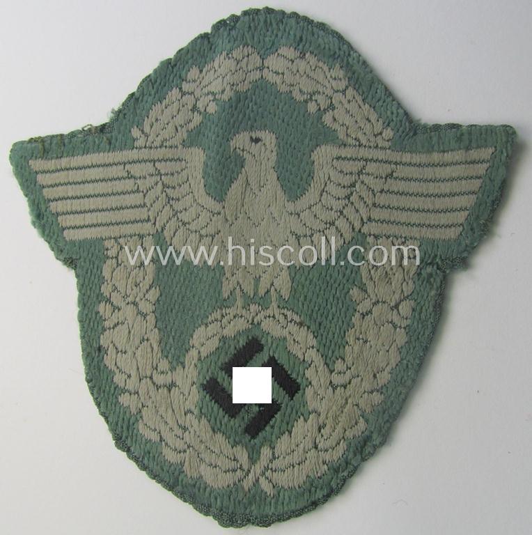 Clearly used- and/or tunic-removed, police- (ie. 'Polizei'-) related armbadge (ie. arm-eagle) being a typical 'BeVo'-woven example