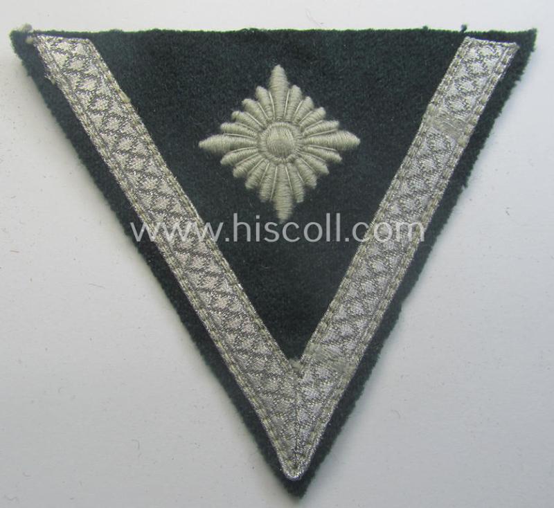WH (Heeres) 'Armwinkel' (or: arm-chevron) as executed on typical darker-green-coloured wool as was specifically intended for usage by a soldier with the (unusually encountered!) rank of an: 'Gefreiter mit mehr als 6 Dienstjahren'
