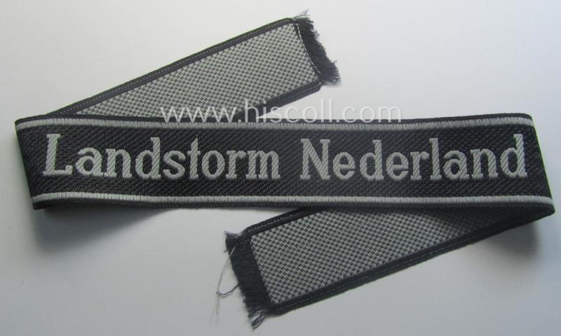 Waffen-SS, 1943/44 pattern cuff-title (ie. 'Ärmelstreifen') depicting the machine-woven Latin script text in silver-grey linnen as was intended for a member of the: '34. SS-Freiwilligen-Grenadier-Division': “Landstorm Nederland”