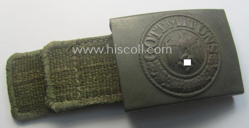 WH (Heeres) 'tropical-issued' belt-buckle being a clearly maker- (ie. 'HA'-) marked (and/or: '42'-dated) field-grey-coloured example that comes mounted onto its original, greenish-coloured- (and/or: 'webbing'-based-) tab