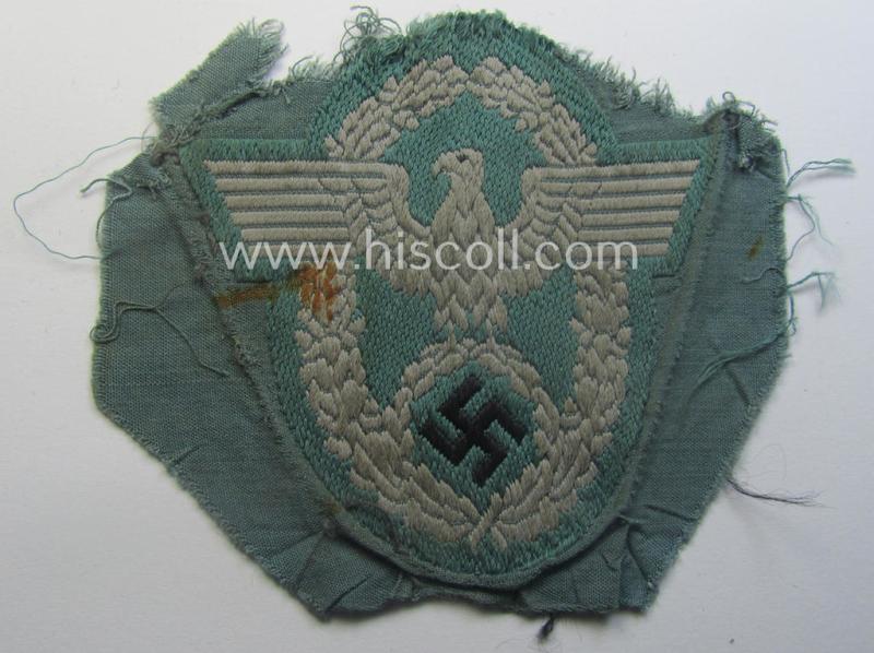 Clearly used- and/or tunic-removed, police- (ie. 'Polizei'-) related armbadge (ie. arm-eagle) being a typical 'BeVo'-woven example