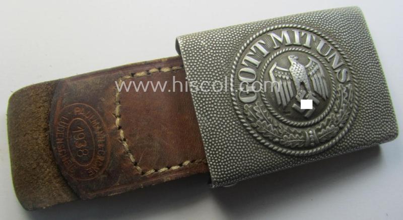 WH (Heeres) 'standard-pattern', field-grey-toned- and aluminium-based belt-buckle being a maker- (ie. 'Paulmann & Crone'-) marked- and/or: '1938'-dated example that comes mounted onto its leather-based tab