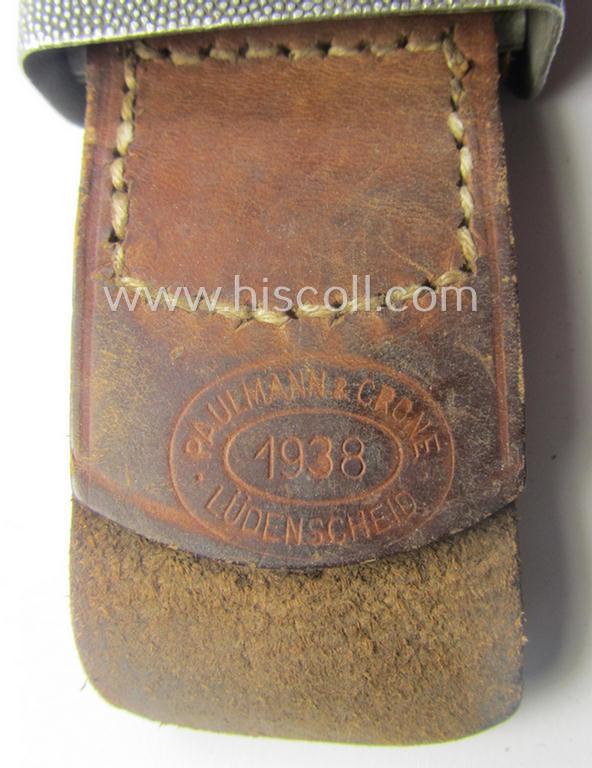 WH (Heeres) 'standard-pattern', field-grey-toned- and aluminium-based belt-buckle being a maker- (ie. 'Paulmann & Crone'-) marked- and/or: '1938'-dated example that comes mounted onto its leather-based tab