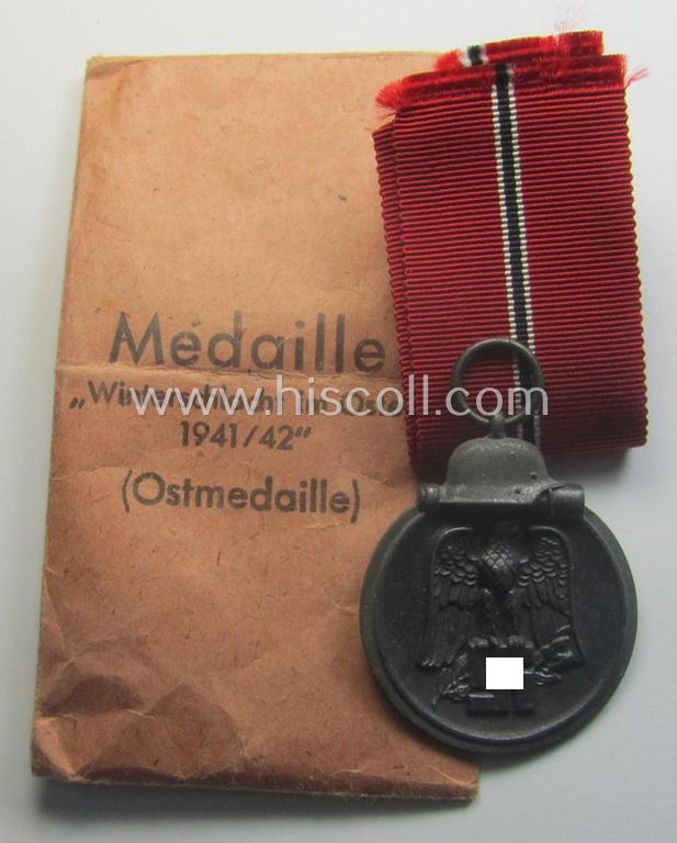 Neatly maker- (ie. '19'-) marked medal: 'Winterschlacht im Osten 1941/42' that came stored in its period pouch by the company: 'E. Ferd. Wiedmann'