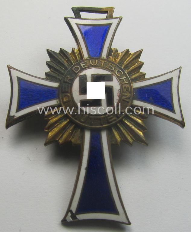 Regrettably damaged (ie. relic) 'Ehrenkreuz der deutschen Mutter - dritte Stufe' (or: bronze-class mothers'-cross) being a non-maker-marked example that comes mounted onto a (period-attached) 'clasp'