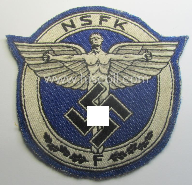 Very unusual, darker-blue-coloured: N.S.F.K.- (or: 'National Socialistisches Flieger Korps') sports-shirt breast-eagle for 'förderende Mitglieder' being a nicely 'BeVo'-woven- (and carefully 'cut-out'!) example