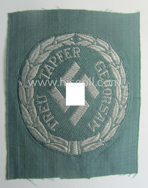 Officers'- (ie. evt. NCO-) type, so-called: 'Schutzmannschaften'- (ie. 'Schuma'-) armshield being executed in silver-grey-coloured 'flatwire'-thread onto a police-green-coloured background