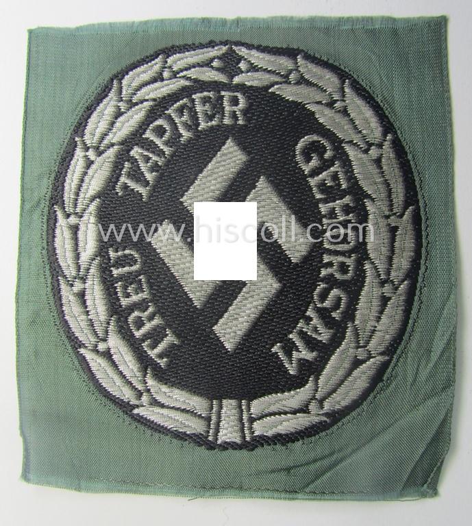 Officers'- (ie. evt. NCO-) type, so-called: 'Schutzmannschaften'- (ie. 'Schuma'-) armshield being executed in silver-grey-coloured 'flatwire'-type thread onto a field-grey-coloured background