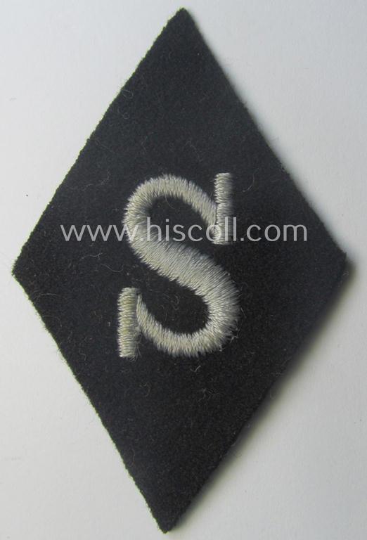 Waffen-SS-pattern, machine-embroidered and black-coloured sleeve-insignia (ie. 'Ärmelraute') depicting a captital: 'S'-character as was used to signify the function of: 'Schirrmeister' within the: 'Waffen-SS'