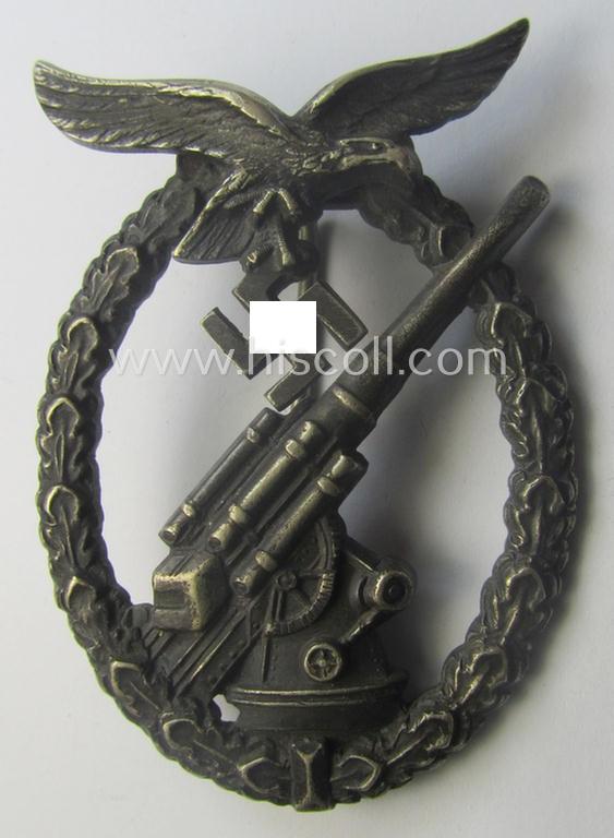 WH (Luftwaffe) 'Flakkampfabzeichen' being a detailed 'Buntmetall'-based and clearly maker-marked example as was produced by the: 'C.E. Juncker'-company and that comes as moderately worn