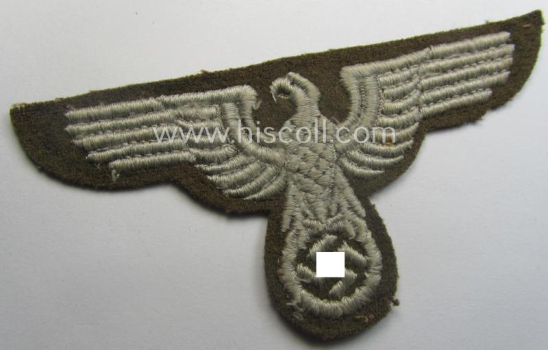 Machine-embroidered arm-eagle (ie. 'Ärmeladler') as was specifically intended for usage on the brownish-green-coloured tunics of officials of the: 'Reichsministerium für besetzte Ostgebiete' (ie. 'R.M.b.O.')