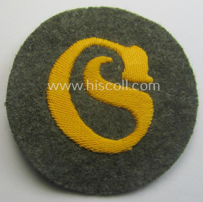 WH (Heeres) so-called: trade- and/or special-career arm-insignia (ie. 'Laufbahn- o. Tätigkeitsabzeichen') as intended for a: 'Schirrmeister' (being a neatly hand-embroidered variant as mounted onto a field-grey-coloured- and woolen-based background)