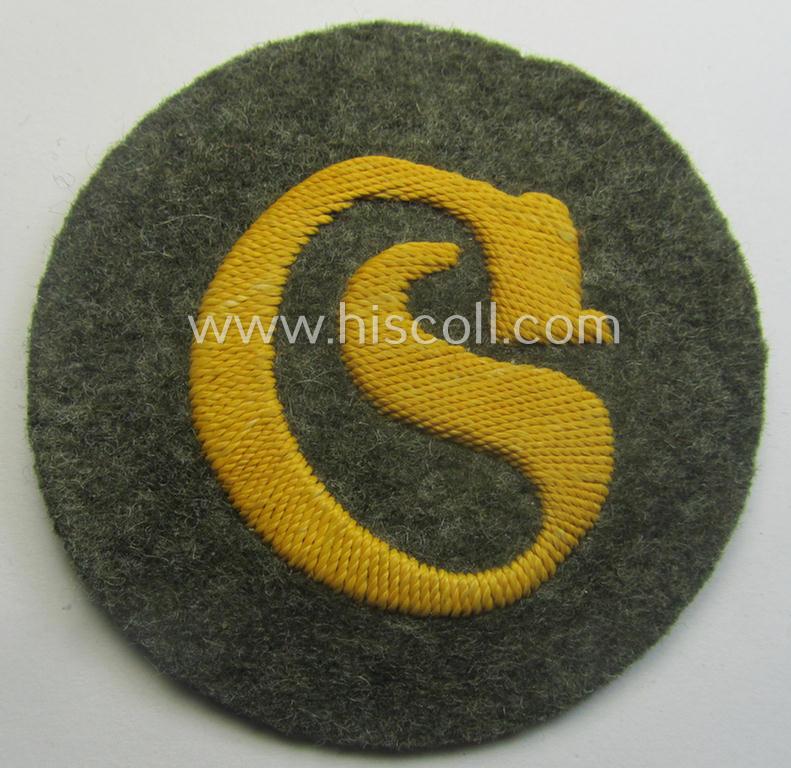 WH (Heeres) so-called: trade- and/or special-career arm-insignia (ie. 'Laufbahn- o. Tätigkeitsabzeichen') as intended for a: 'Schirrmeister' (being a neatly hand-embroidered variant as mounted onto a field-grey-coloured- and woolen-based background)