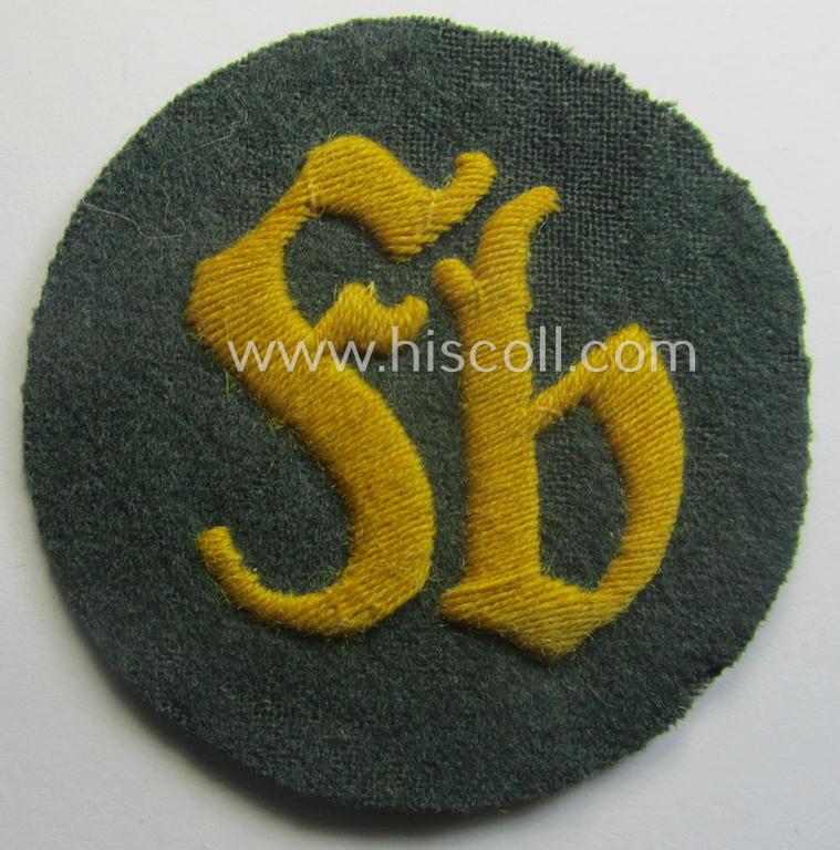 WH (Heeres) so-called: trade- and/or special-career arm-insignia as was intended for a: 'Festungsbau-Feldwebel' (being a neatly hand-embroidered 'variant' as mounted on darker-green-coloured wool)