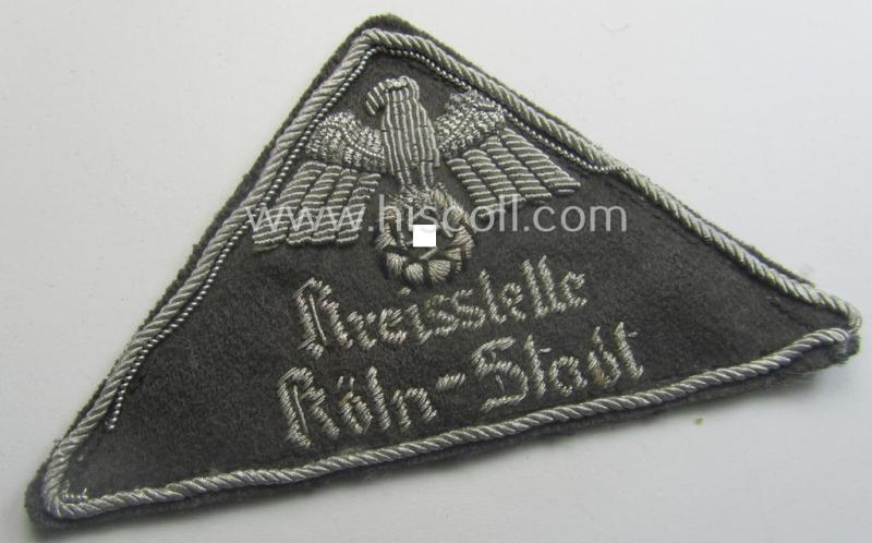 German Red Cross (ie. 'Deutsches Rotes Kreuz' or 'DRK') greyish-coloured- and/or triangular-shaped and neatly hand-embroidered (ie. typically officers'-pattern!) arm-eagle entitled: 'Kreisstelle Köln-Stadt'