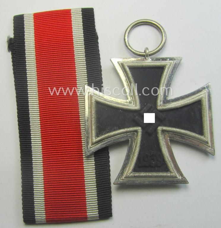 Iron Cross 2nd class (or: 'EK II. Klasse') being a maker- (ie. '23'-) marked example that comes together with its confectioned ribbon (ie. 'Bandabschnitt') as was produced by the maker (ie. 'Hersteller'): 'AG für Heeresbedarf….'